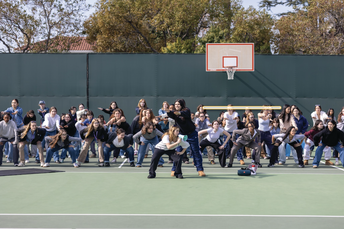 Seniors practice their Spirit Week routine on the tennis courts.